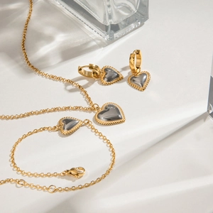 Two-tone gold and silver heart jewelry set including necklace, bracelet, and earrings
