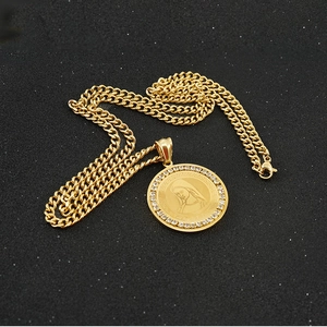 Detailed view of 18K gold plated Cuban chain and round portrait pendant with zircons