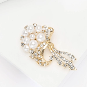 Elegant gold bouquet brooch with pearls and rhinestones on a clean white background