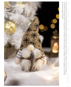 Close-up of a Christmas gnome with snowflake knitted hat and white beard in a cozy setting
