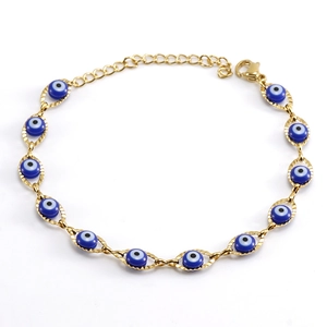 Macro detail of gold 18K stainless steel bracelet with blue Turkish Evil Eye beads