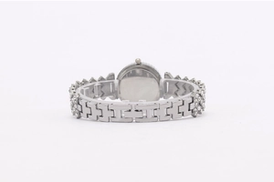 Detail of silver watch back showing metal geometric band with sparkling diamond accents
