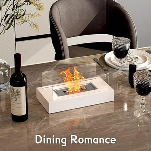 Modern white tabletop ethanol fireplace with glass panels on a marble dining table