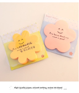 Close-up of flower shaped sticky notes with smiley faces in pink and yellow colors