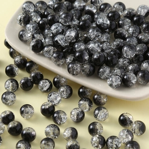 Detailed macro view of 10mm black and clear cracked glass beads for DIY jewelry making