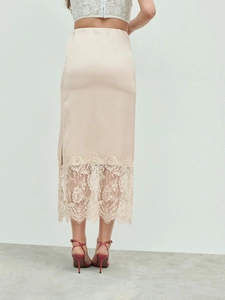 Detail of beige midi skirt with delicate lace patchwork hem and elegant back view