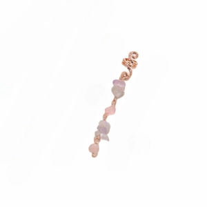 Detail of rose gold spiral hair ring with pink natural raw stone pendant and scrollwork