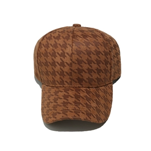 Close-up of brown houndstooth pattern baseball cap with premium structured fabric texture