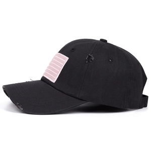Distressed black baseball cap with pink embroidered flag patch and vintage ripped details
