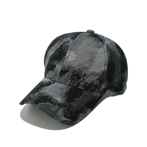 Detailed side view of washed denim baseball cap with black and grey marble texture