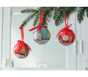Christmas ball ornaments with Santa and reindeer hanging on a green pine branch