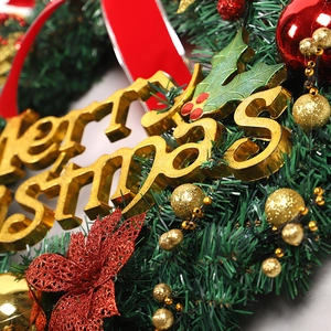 Christmas wreath with red bows, golden balls, and Merry Christmas sign on white background