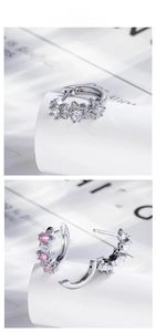 Detailed view of star-shaped silver earrings with white and pink cubic zirconia stones