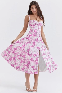 Detail of pink floral dress featuring corset bodice design and high side slit