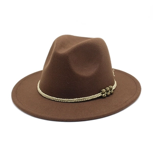 Detail of dark brown wool felt fedora featuring beige braided band and vintage metal beads