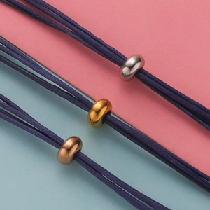 Macro shot of stainless steel beads in silver, gold, and rose gold for DIY jewelry