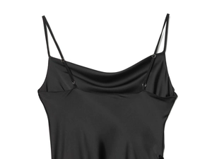 Detail of the black satin cowl neck dress featuring adjustable spaghetti straps and silky texture