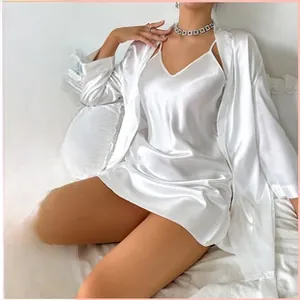 Detail of the elegant white imitation silk sleepwear set with a camisole dress and robe