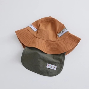 Detail view of the embroidered train patches and the quick-dry fabric of the kid sun hat