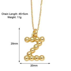 Detail view of gold letter Z pendant with ball texture and size measurement 29mm