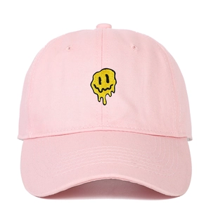 Pink cotton baseball cap with embroidered melting yellow smiley face and curved brim