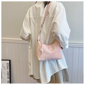 Pink pleated dumpling bag for women with ripple texture and beaded drawstring details