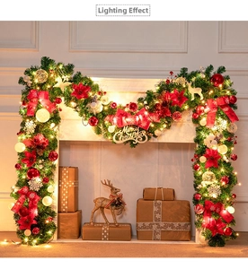 Detail of 270cm PVC Christmas garland with LED lights, red bows, and festive ornaments