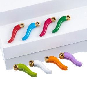Detailed view of colorful chili pepper charms with gold hooks in various enamel finishes