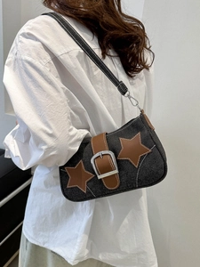 Detailed side view of Y2K denim shoulder bag with brown star patches and metal buckle