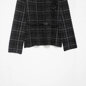 Women's grey plaid knit coat with a slim black leather belt and sequin waist details
