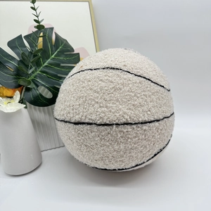 Detail view of the soft off-white plush basketball pillow with textured black stitch lines