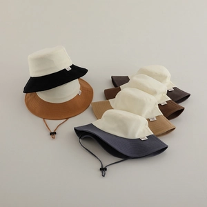 Detail of multi-color canvas sun hats with adjustable windproof cords for outdoor wear