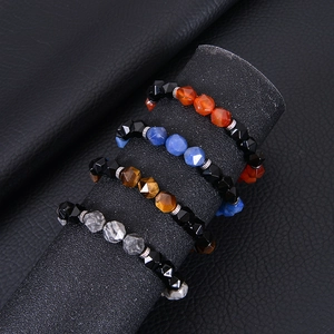 Elastic beaded bracelets with faceted agate, obsidian and map stone on a black display