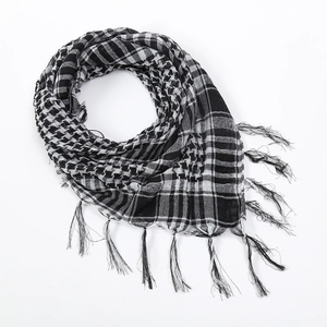 Detail of black and white shemagh scarf with houndstooth pattern and tassel edges