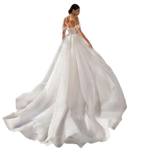 Elegant off-shoulder white bridal gown with intricate lace embroidery and long cathedral train