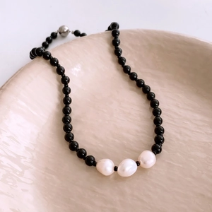 Ethnic style black beaded necklace with white pearls and magnetic spherical clasp
