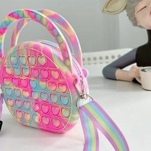 Detail of round heart-shaped rainbow silicone push-pop fidget shoulder bag for kids