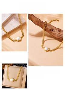 Detail of vintage gold plated wheat leaf chain with a square pearl pendant necklace