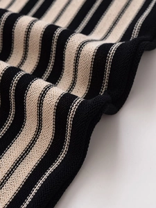 Detail shot of the black and beige striped knit texture on high-quality linen-feel fabric