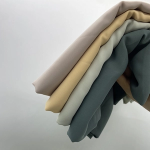 Elegant pleated satin chiffon long scarves stacked in multiple colors on white background