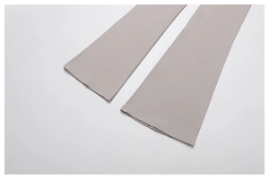 Detailed view of light grey flared yoga pants featuring durable double-stitch hem craft