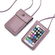 Detailed view of dust pink touchscreen crossbody phone bag with gold bee ornament