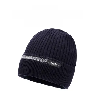 Close-up of thick rib-knit winter beanie with grey herringbone strap and fashion patch