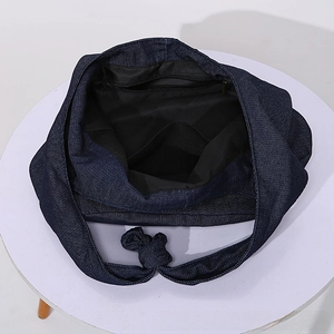 Detail view of denim tote bag showing black fabric lining and functional inner pockets