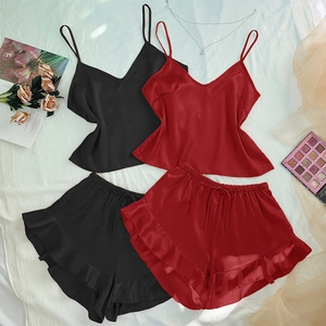 Two-piece satin pajama set with V-neck camisole and ruffled shorts in black and red