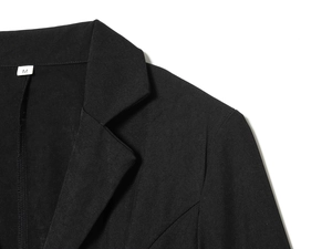 Detail of notch lapel and shoulder on black blazer with M size label and twill fabric texture