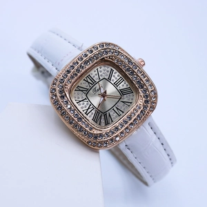 Close-up of square rose gold watch with sparkling diamonds and Roman numeral dial
