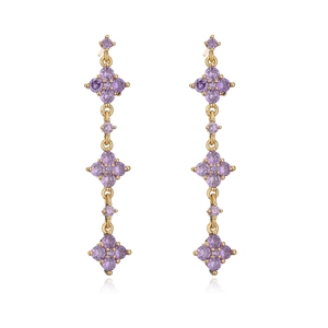 Detail of 18K gold plated drop earrings with purple zircon and clover-shaped tassels