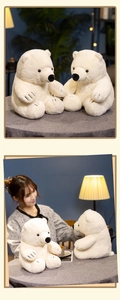 Close-up of soft plush polar bear doll with fluffy white fur and detailed black stitching