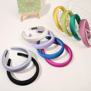 Close-up of colorful padded headbands in satin fabric showing diverse vibrant colors